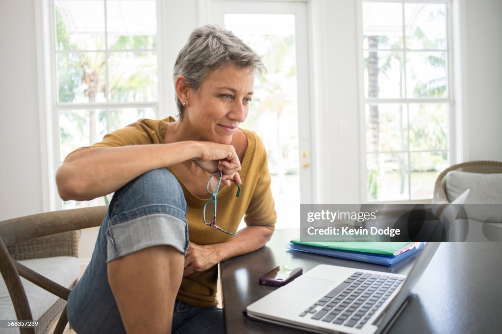 Woman using laptop in living room