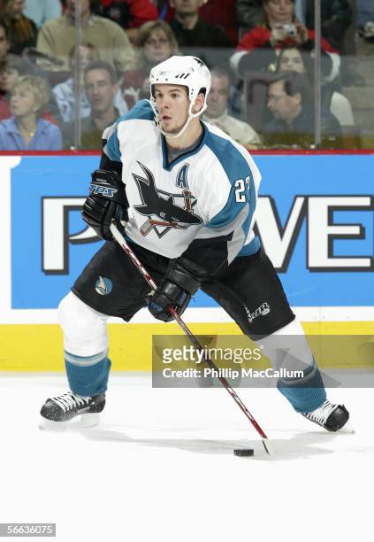 Scott Hannan of the San Jose Sharks skates with the puck during the game against the Ottawa Senators on January 12, 2006 at the Corel Centre in...