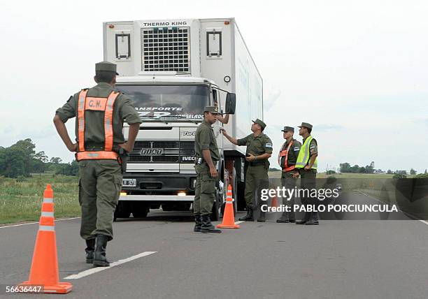 Efectivos de la Gendarmeria argentina informan a un camionero sobre el corte de la ruta por parte ambientalistas argentinos cerca de la frontera con...