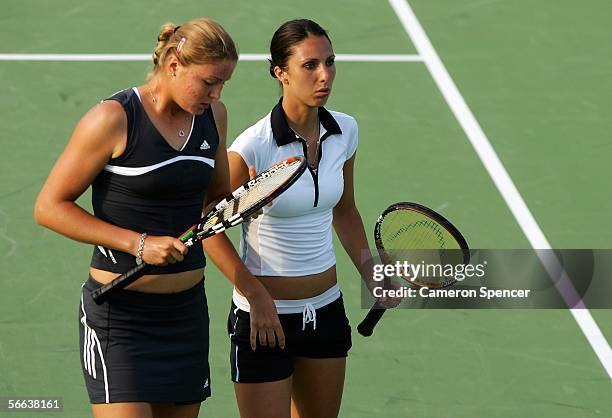 Dinara Safina of Russia and Anastasia Myskina of Russia talk tactics during their doubles match against Stephanie Foretz of France and Antonella...