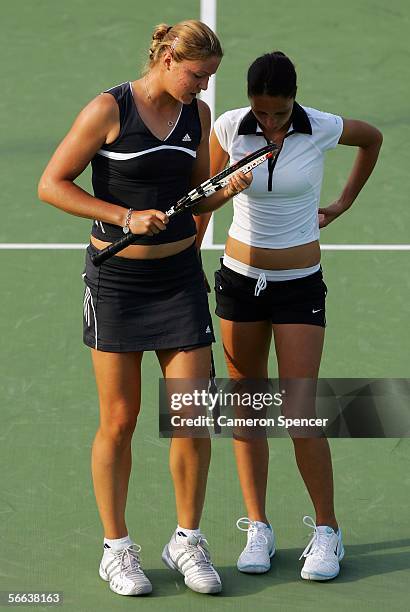 Dinara Safina of Russia and Anastasia Myskina of Russia talk tactics during their doubles match against Stephanie Foretz of France and Antonella...