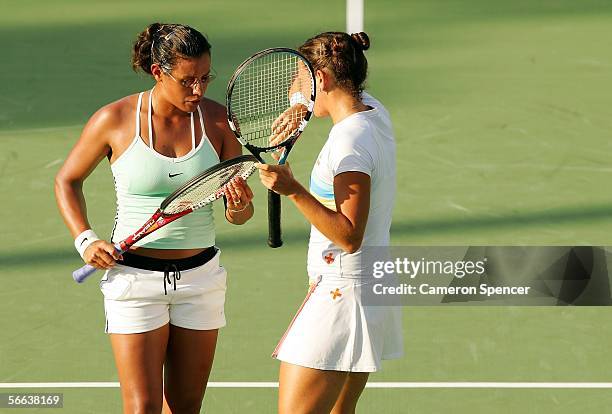 Stephanie Foretz of France and Antonella Serra Zanetti of Italy talk tactics during their doubles match against Dinara Safina of Russia and Anastasia...