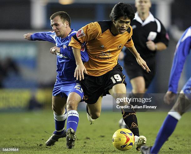 Jody Morris of Millwall battles with Seol of Wolves during the Coca-Cola Championship match between Millwall and Wolverhampton Wanderers at The New...