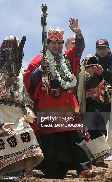 Bolivia's President-elect Evo Morales waves after a ritual perfomed by four Amautas during an elaborate ceremony where he was crowned as supreme...