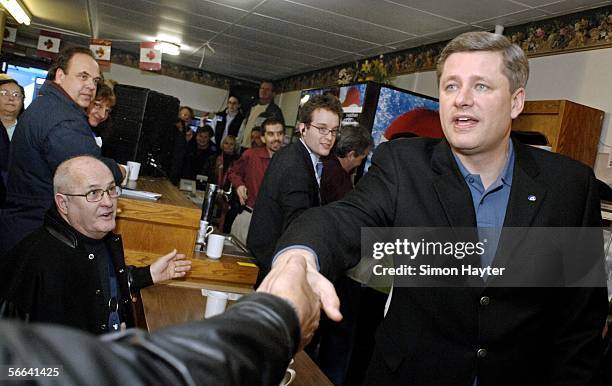 Conservative Party leader Stephen Harper shakes hands with supporters at the Gardenia Restaurant in Strathroy, Ontario, Canada. The old-fashioned...