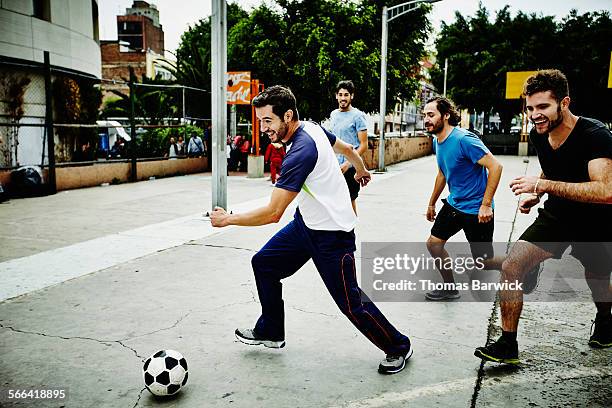 soccer player dribbling ball past opposing players - mexico city park stock pictures, royalty-free photos & images