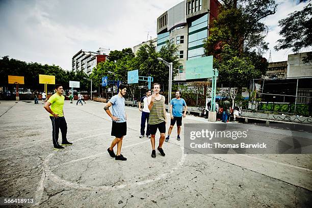 group of soccer players standing on outdoor court - sport community center stock pictures, royalty-free photos & images