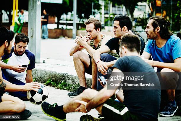 friends sitting in discussion on outdoor court - medium group stock pictures, royalty-free photos & images