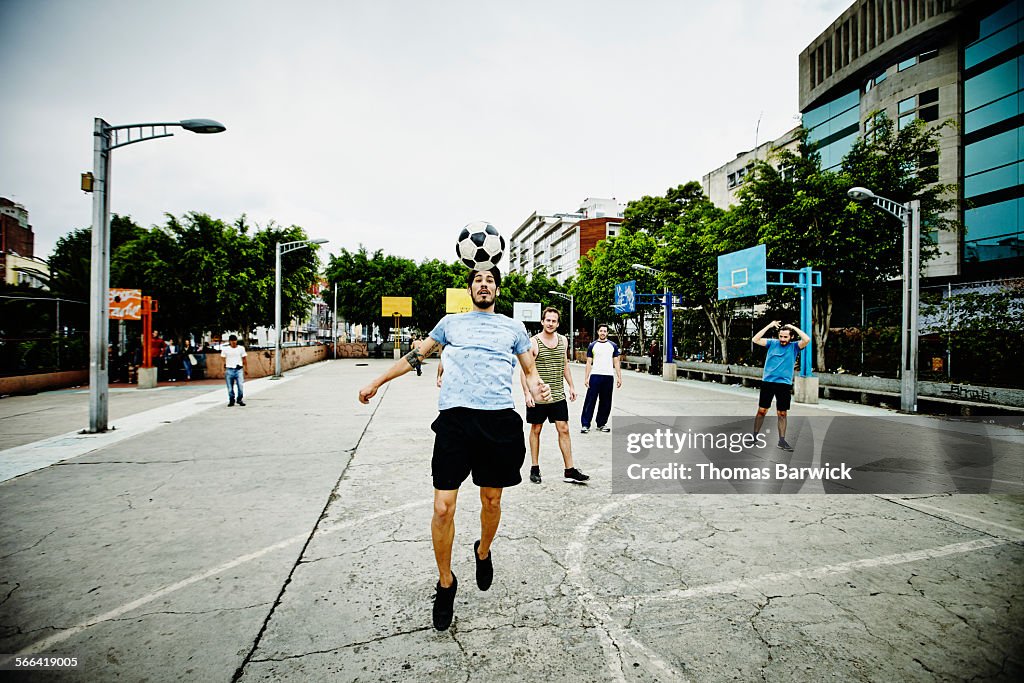 Soccer player heading ball during pick up game