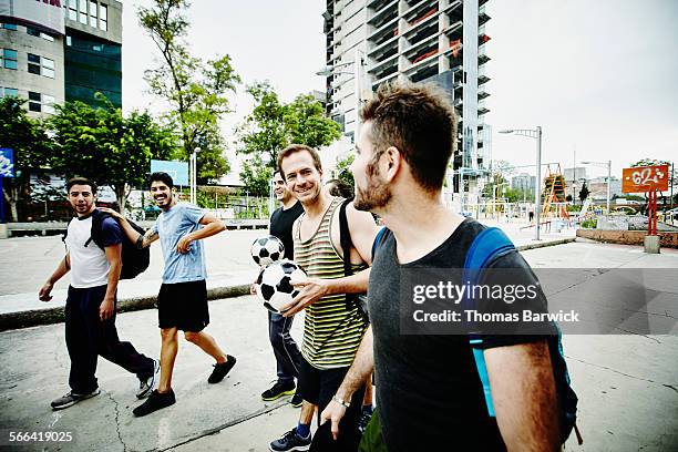 friends preparing to play pick up soccer game - five friends unity stock pictures, royalty-free photos & images