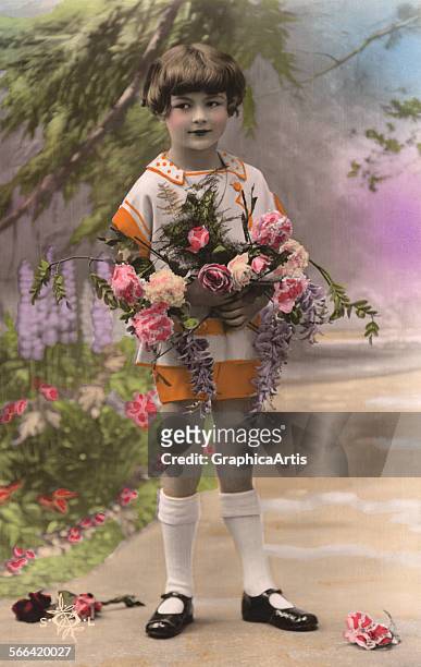 Hand-colored studio photograph of a young French boy holding roses; silver print, 1936.