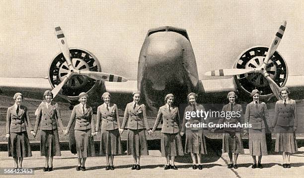 Stewardesses holding hands in front of a large twin-propeller commercial airplane; screen print from a photograph, 1940.