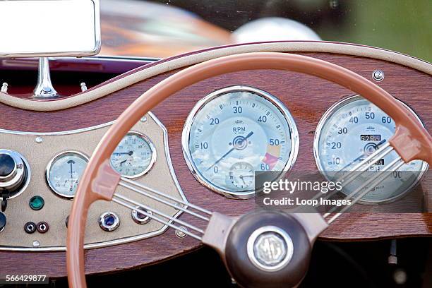 Close up view of the steering wheel and dashboard of a classic car at Goodwood revival.