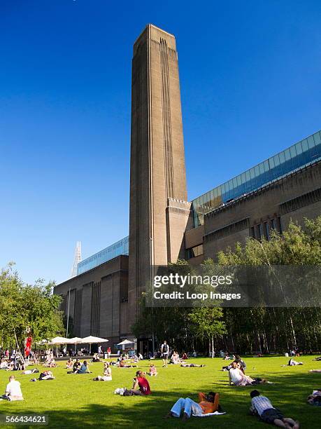 People enjoying a summer day in front of the Tate Modern gallery in London.