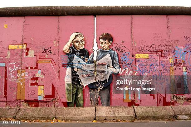 Colourful pink mural on the Berlin Wall.