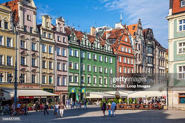 Outdoor restaurant bars and colourful medieval houses in Wroclaw's old town Market Square or Rynek.