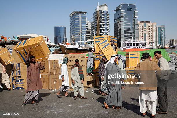 Unloading boxes on the dockside at Dubai Creek.