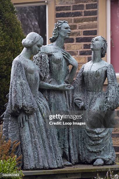 Bronze statue of the Bronte sisters in the grounds of the Parsonage Museum.