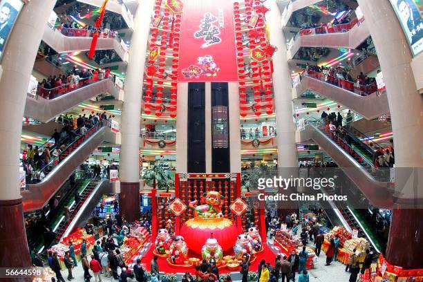 Customers shop for Chinese traditional decorations at a shopping mall on January 22, 2006 in Xian of Shaanxi Province, China. As the Chinese Spring...