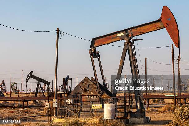 Pump jacks at the Lost Hills Oil Field and hydraulic fracking site. Kern County, San Joaquin Valley, California.