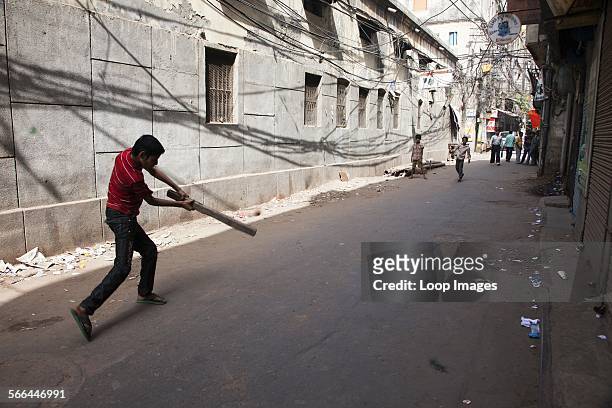 Boys playing cricket in the Old Delhi.