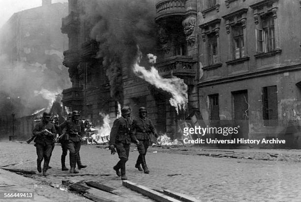 Photograph of a patrol of SS men on Nowolipie Street during the Warsaw Ghetto Uprising. Dated 1943.