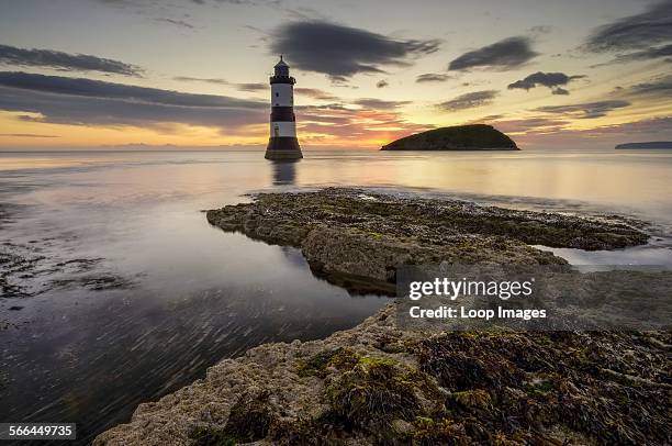 Trwyn Du lighthouse and puffin island at sunrise.
