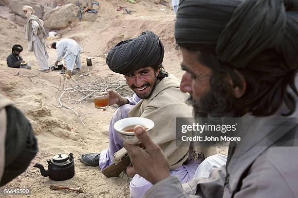 Guerrillas from the Bugti tribe drink tea at a remote camp outside of Dera Bugti, in the province of Balochistan, Pakistan on January 22, 2006. The...