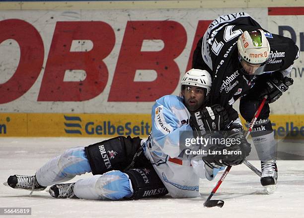 Martin Walter of Hamburg in action with Mark Greig of Iserlohn during the DEL Bundesliga match between Iserlohn Roosters and Hamburg Freezers at the...