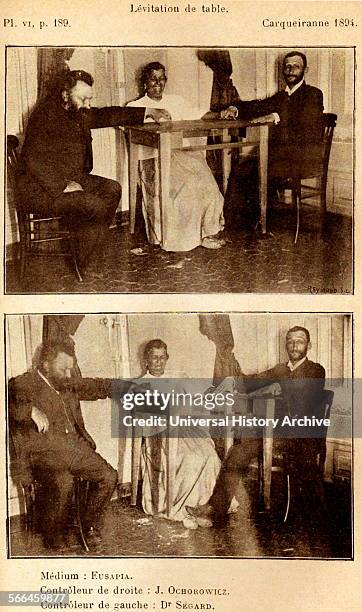Séance held by Madame Eusapia showing the levitation of a table, 1894.