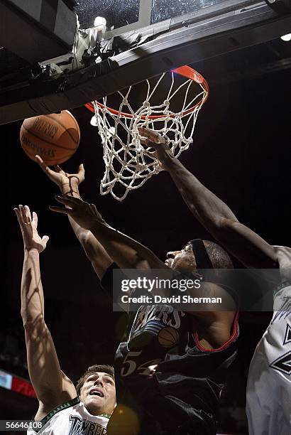 Lee Nailon of the Philadelphia 76ers goes up to the basket for the shot against Wally Szczerbiak and Kevin Garnett of the Minnesota Timberwolves on...