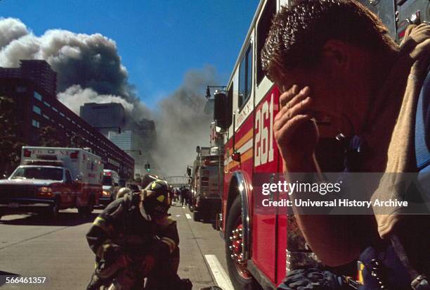 Colour photograph of a New York Fire-fighter amid the rubble of the World Trade Centre following the 9/11 attacks. Dated 2001.