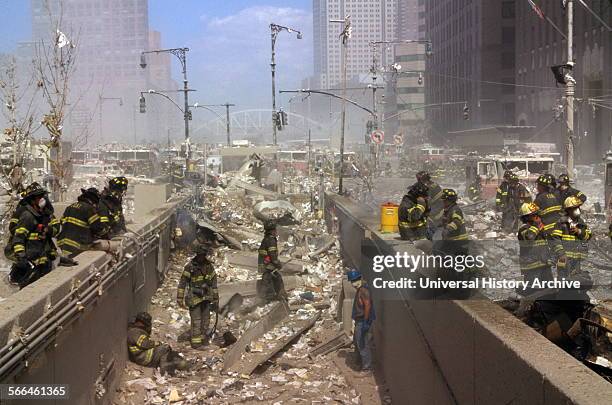 Colour photograph of New York Firefighters amid the rubble of the World Trade Centre following the 9/11 attacks. Dated 2001.