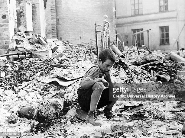 At the beginning of World War two, a Polish boy sits grieving in the ruins of a street in Warsaw, Poland, September 1939.