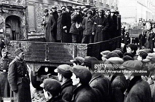 Photograph of Young Jewish men being carted off in the Warsaw Ghetto. Dated 1941.