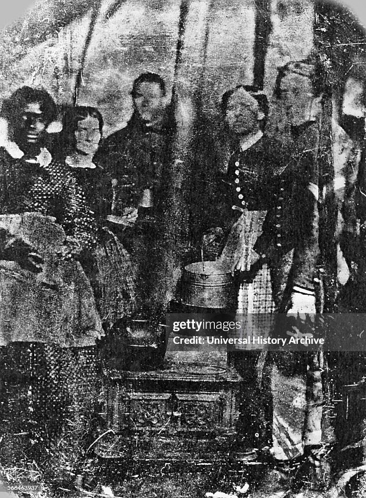 Medical staff and soldiers in a hospital tent.