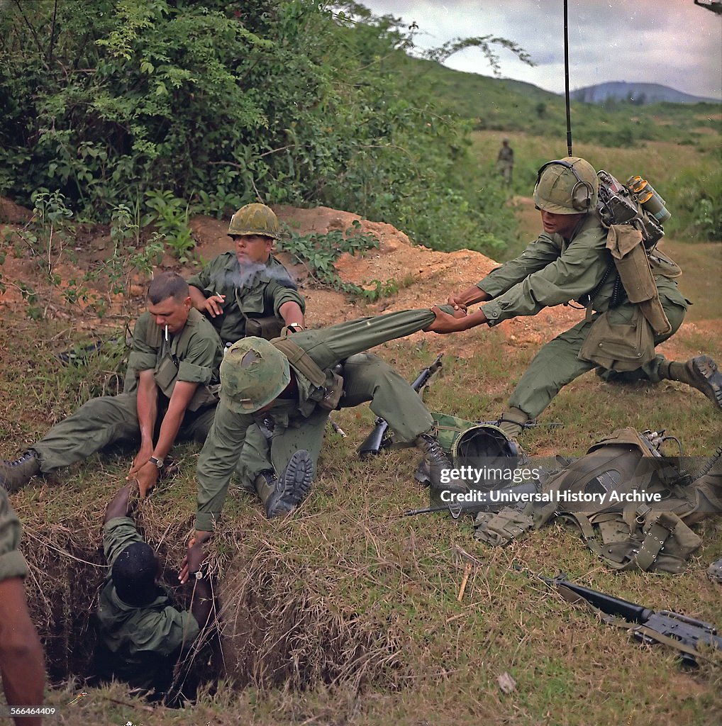 American soldiers uncovering a Vietcong tunnel.