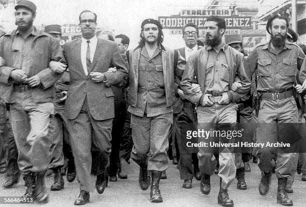 Fidel Castro Left next to Osvaldo Dortic's with Che Guevara at a parade during March 1960 in Havana.