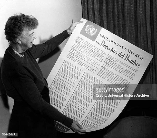 Eleanor Roosevelt displays a Spanish language version of the Universal Declaration 1949.