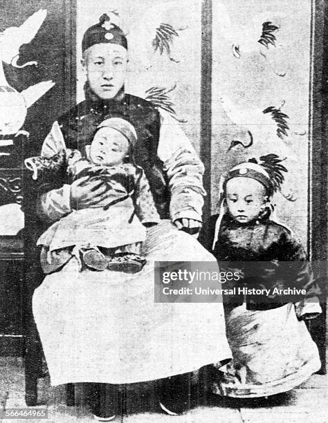 Three-year-old Chinese Emperor Puyi , standing next to his father and his younger brother Pujie.