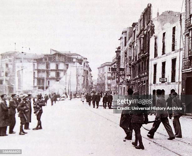The town of Oviedo in Spain, is re-taken by civil guards after riots in 1936.