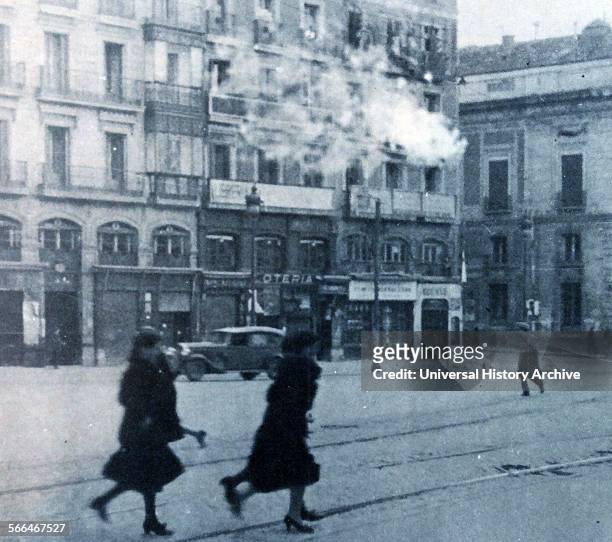 Shells explode and civilians run for cover during an attack on Madrid, during the Spanish Civil War, 1936.