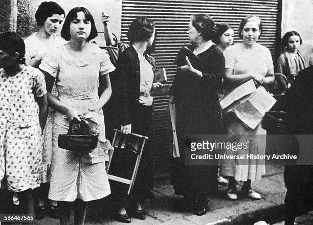 Women queue for basic food supplies in Spain, during the Spanish Civil War.