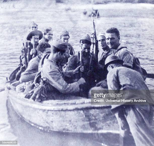 Republican soldiers cross the Erbo River during the Battle of the Ebro, the longest and largest battle of the Spanish Civil War. It took place...