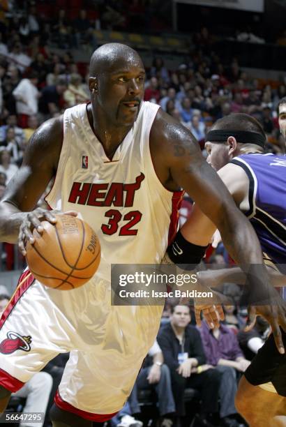 Shaquille O'Neal of the Miami Heat drives against Brad Miller of the Sacramento Kings on January 22, 2006 at American Airlines Arena in Miami,...