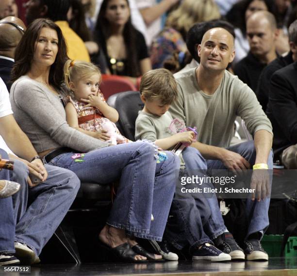 Former women's tennis star Steffi Graf and her husband men's tennis star Andre Agassi and their children watch the Sacramento Kings take on the Miami...