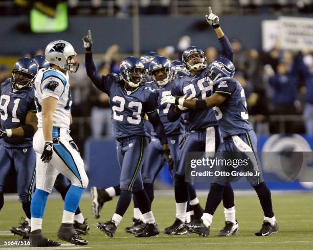 The Seattle Seahawks' defense celebrates their third interception of the game in second half action against the Carolina Panthers during the NFC...