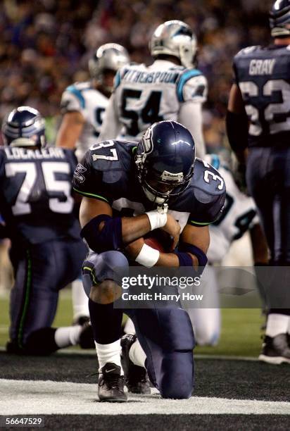 Running back Shaun Alexander of the Seattle Seahawks celebrates his touchdown in the fourth quarter of the NFC Championship Game against the Carolina...