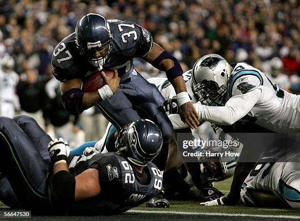 Running back Shaun Alexander of the Seattle Seahawks falls in for a touchdown in the fourth quarter of the NFC Championship Game against the Carolina...