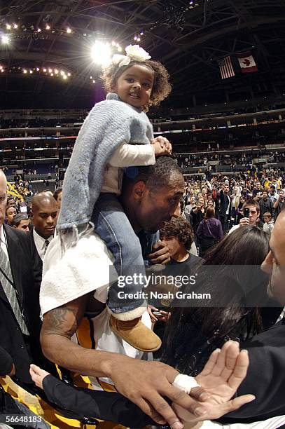 Kobe Bryant of the Los Angeles Lakers walks off the court with his daughter Natalia after he scored 81 points against the Toronto Raptors on January...